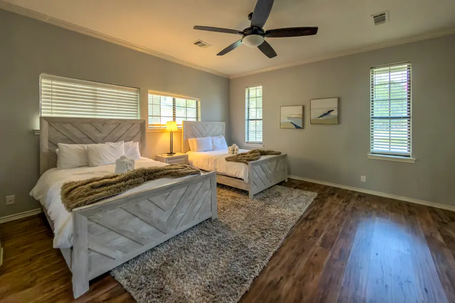 Second view of the bedroom with two beds and a ceiling fan