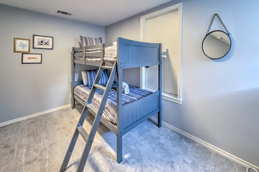 Bunk room with grey twin-over-twin bunk beds